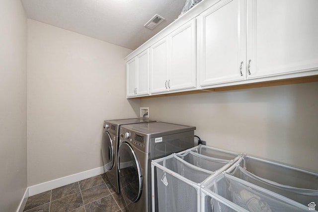 laundry area featuring cabinet space, washing machine and dryer, and baseboards