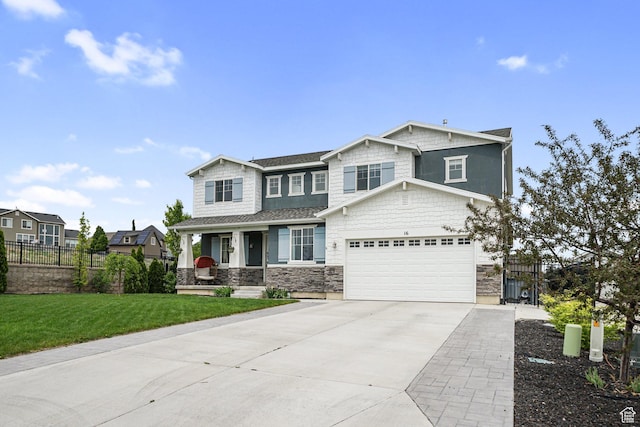 craftsman house featuring covered porch, driveway, stone siding, and a garage