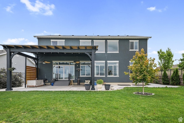 rear view of property featuring stucco siding, a pergola, a patio, and a ceiling fan