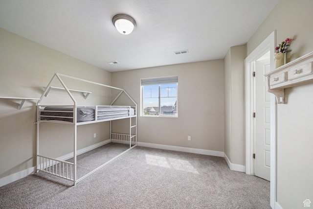 unfurnished bedroom featuring carpet and baseboards
