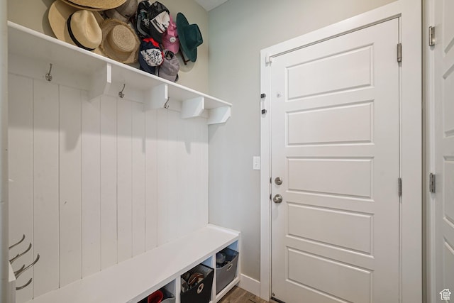 mudroom featuring wood finished floors and baseboards