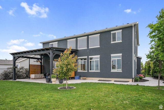 rear view of property with stucco siding, a ceiling fan, a patio area, and a pergola