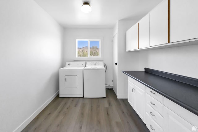1665 S Kennedy Dr, Marysvale, UT 84750 - laundry area with washer and clothes dryer, cabinet space, baseboards, and light wood-style floors
