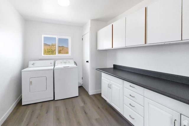 1665 S Kennedy Dr, Marysvale, UT 84750 - laundry area featuring washer and dryer, baseboards, cabinet space, and light wood-style flooring