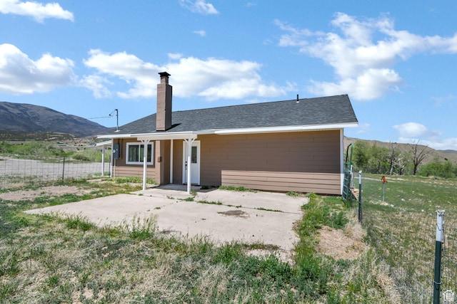 1665 S Kennedy Dr, Marysvale, UT 84750 - back of property featuring a chimney, fence, and a mountain view