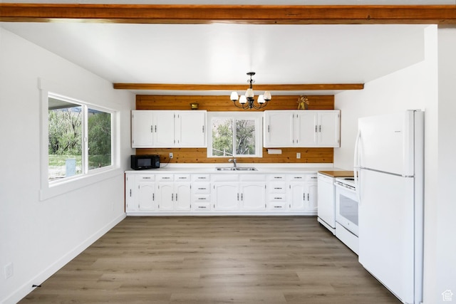 1665 S Kennedy Dr, Marysvale, UT 84750 - kitchen featuring white appliances, a sink, a chandelier, beam ceiling, and white cabinetry
