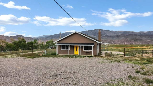 1665 S Kennedy Dr, Marysvale, UT 84750 - bungalow-style house featuring a mountain view, fence, a porch, a chimney, and a view of countryside