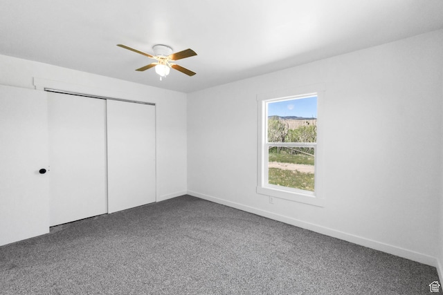 1665 S Kennedy Dr, Marysvale, UT 84750 - unfurnished bedroom with dark colored carpet, a closet, a ceiling fan, and baseboards