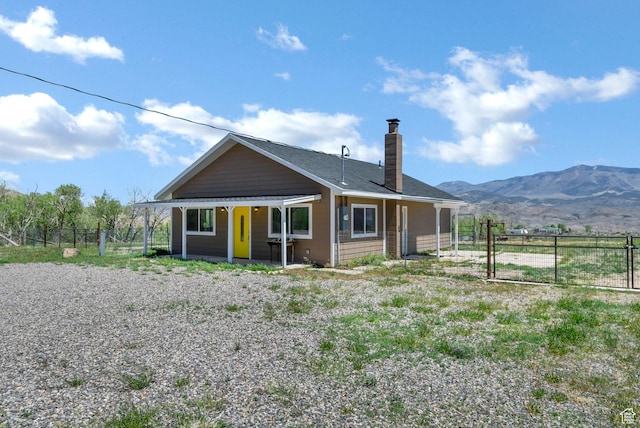 1665 S Kennedy Dr, Marysvale, UT 84750 - view of front of house with a chimney, fence, and a mountain view