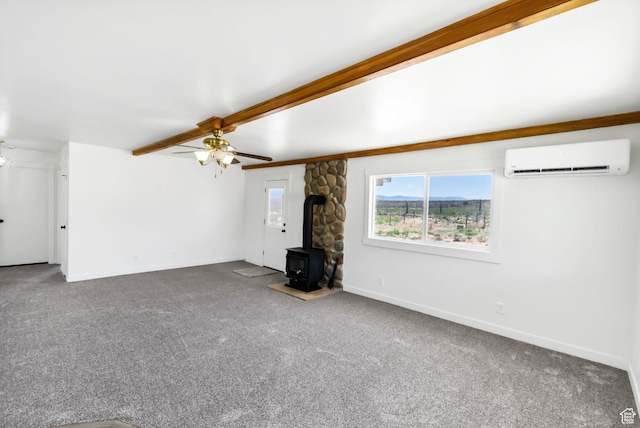 1665 S Kennedy Dr, Marysvale, UT 84750 - unfurnished living room with a wall unit AC, a wood stove, carpet flooring, and baseboards