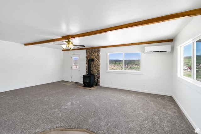 1665 S Kennedy Dr, Marysvale, UT 84750 - unfurnished living room featuring a wood stove, a wall mounted air conditioner, healthy amount of natural light, carpet floors, and beamed ceiling