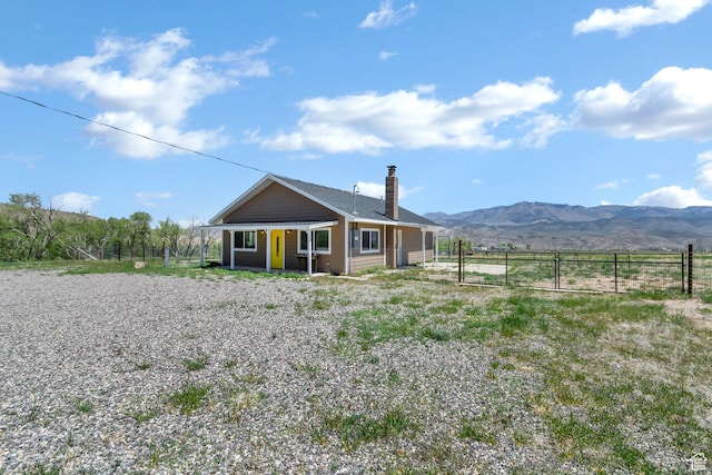 1665 S Kennedy Dr, Marysvale, UT 84750 - back of house with fence, a chimney, and a mountain view