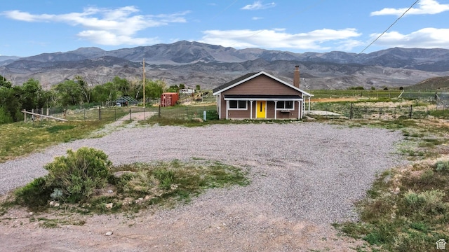 1665 S Kennedy Dr, Marysvale, UT 84750 - view of front of house with fence, a mountain view, a porch, and a view of countryside