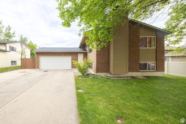 910 W 370 S, Logan, UT 84321 - tri-level home with brick siding, an attached garage, and concrete driveway