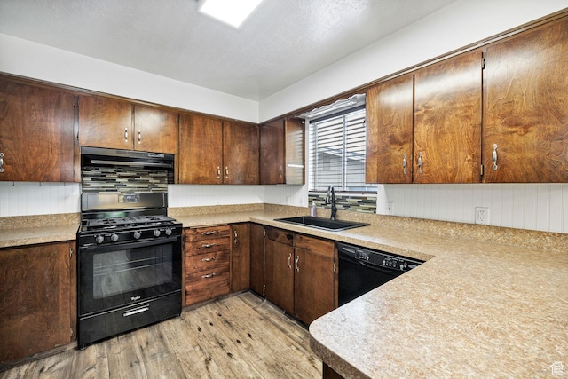 910 W 370 S, Logan, UT 84321 - kitchen with black appliances, a sink, light wood-type flooring, and light countertops