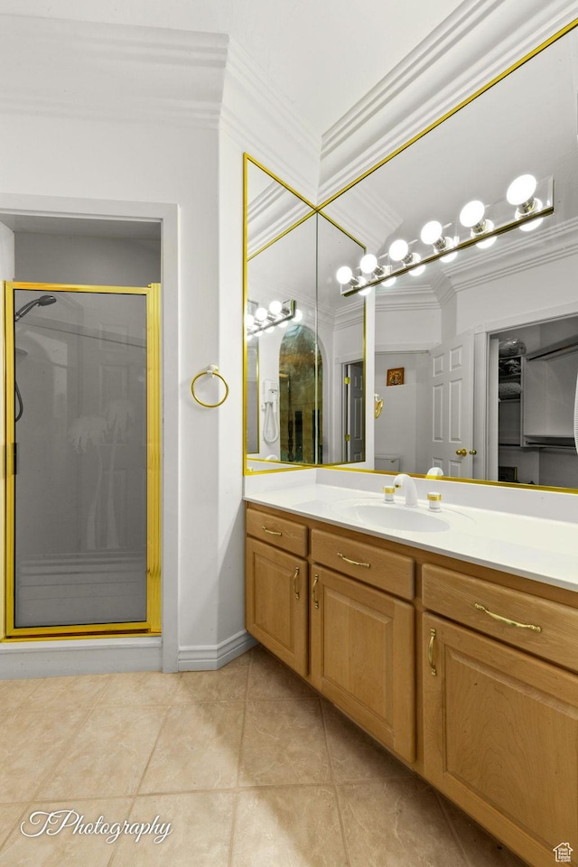 full bathroom featuring ornamental molding, a stall shower, vanity, and tile patterned floors