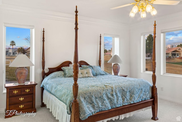 bedroom featuring carpet floors, baseboards, crown molding, and ceiling fan
