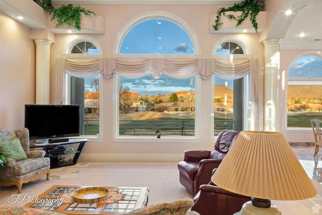 living room with ornate columns, recessed lighting, ornamental molding, and baseboards