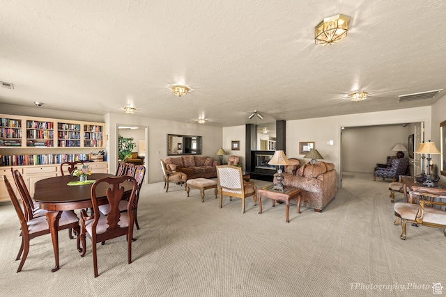 dining room featuring carpet floors and a textured ceiling