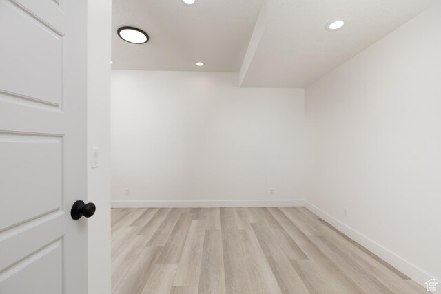 additional living space featuring light wood finished floors, recessed lighting, and baseboards