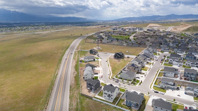 aerial view of property's location with nearby suburban area and a mountain backdrop