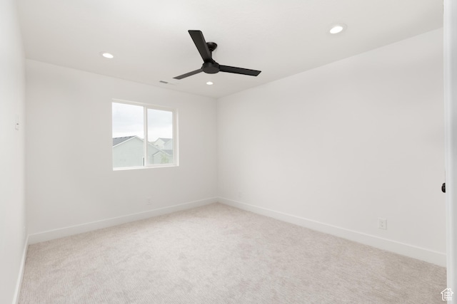 carpeted empty room featuring ceiling fan, recessed lighting, and baseboards