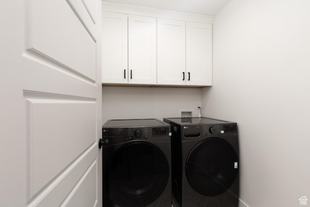 laundry area featuring independent washer and dryer and cabinet space