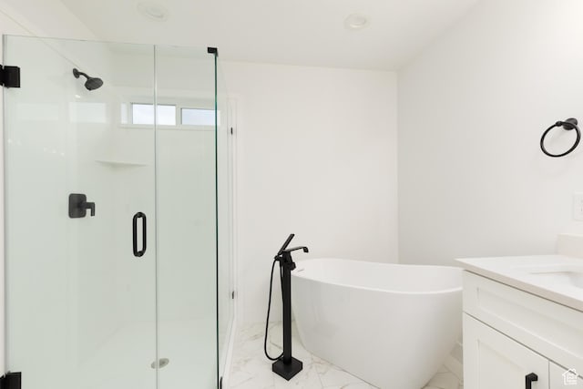 full bathroom with marble look tile flooring, a shower stall, and vanity
