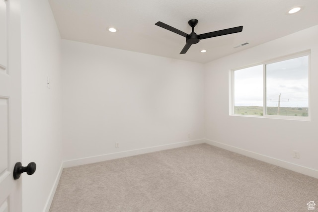 spare room featuring ceiling fan, light colored carpet, recessed lighting, and baseboards