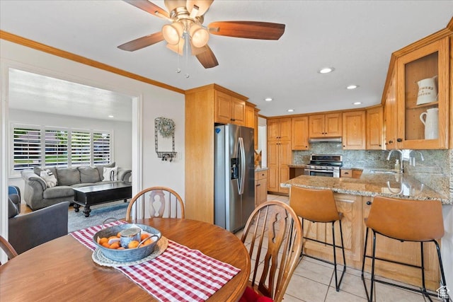 dining room with light tile patterned floors, ceiling fan, recessed lighting, and ornamental molding