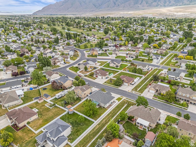 aerial view of property's location featuring a mountain backdrop and nearby suburban area