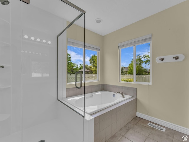 full bath featuring a shower stall, tile patterned flooring, a bath, and baseboards