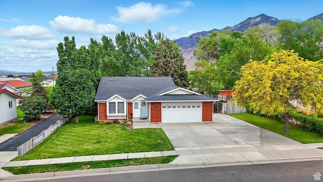 634 W 600 N, Brigham City, UT 84302 - view of front of house featuring brick siding, driveway, a mountain view, and a garage