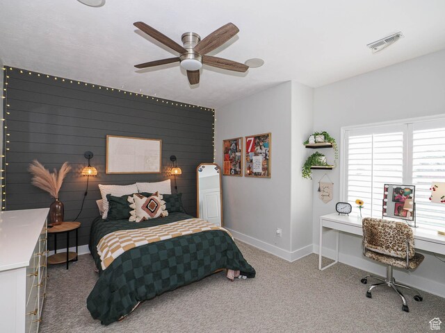 bedroom with baseboards, carpet flooring, an office area, and a ceiling fan