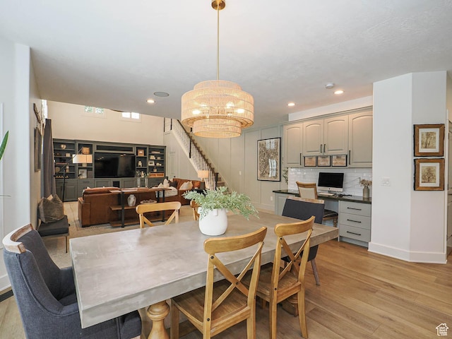 dining area with stairs, light wood-style floors, a chandelier, recessed lighting, and baseboards