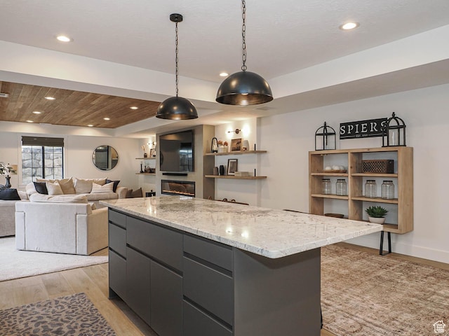 kitchen featuring light wood-style flooring, hanging light fixtures, a center island, recessed lighting, and modern cabinets