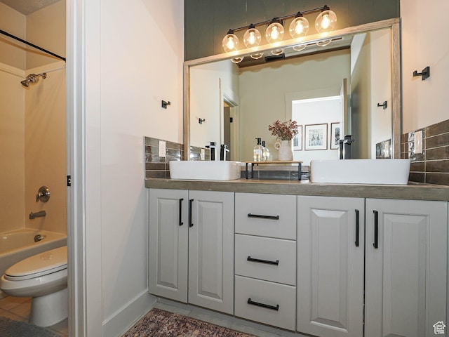 full bath featuring double vanity, tub / shower combination, toilet, tile patterned floors, and baseboards
