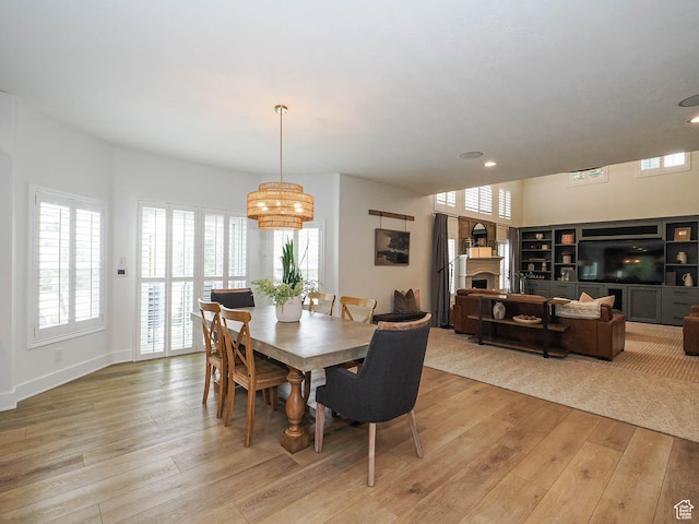 dining room featuring a chandelier, light wood-style floors, plenty of natural light, and recessed lighting