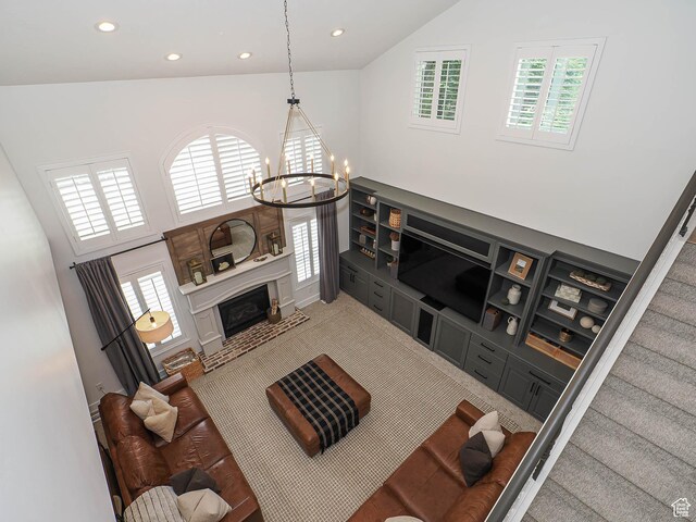 living room featuring high vaulted ceiling, a chandelier, recessed lighting, healthy amount of natural light, and a fireplace