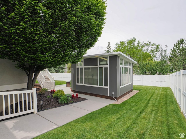 view of yard featuring a sunroom and a patio area