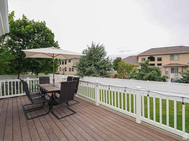 wooden terrace featuring outdoor dining area