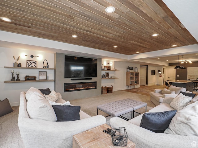 carpeted living area with wooden ceiling, baseboards, recessed lighting, a glass covered fireplace, and a raised ceiling