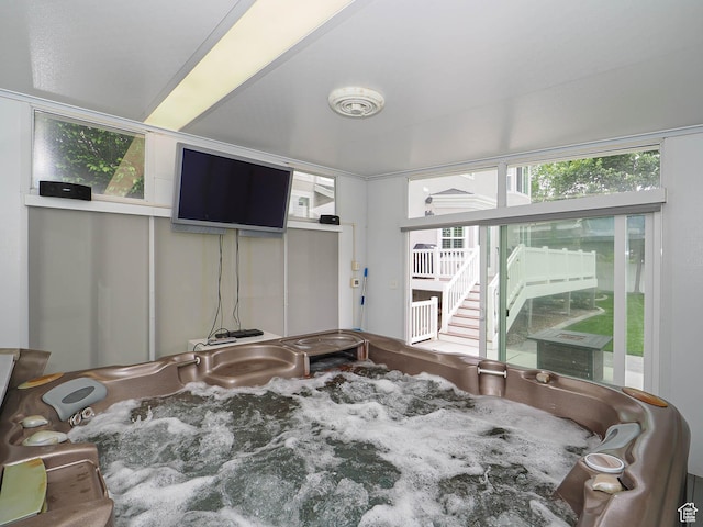 sunroom featuring a hot tub
