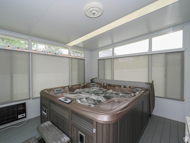 sunroom / solarium featuring a hot tub