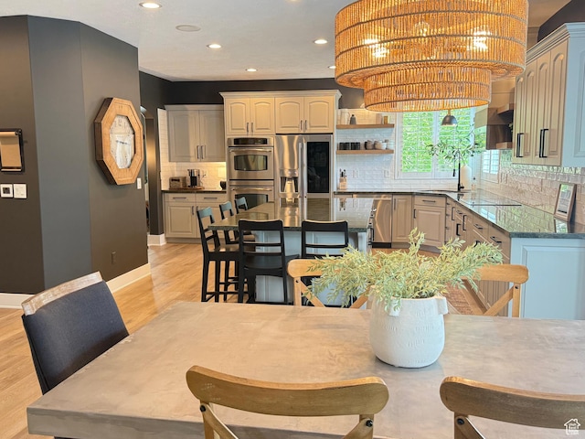 423 E Woodridge Oak Dr S, Draper, UT 84020 - dining area featuring light wood-type flooring, recessed lighting, and baseboards