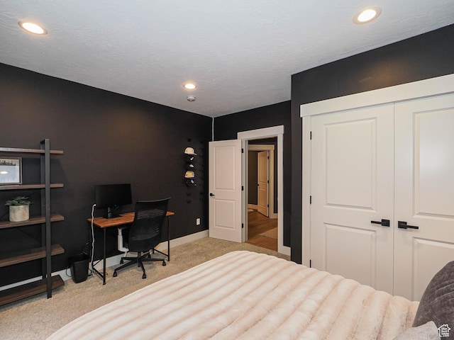 bedroom with light colored carpet, a closet, recessed lighting, and baseboards