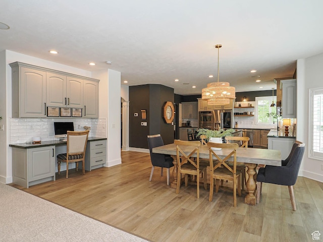 dining room with light wood-style floors, recessed lighting, baseboards, and a chandelier