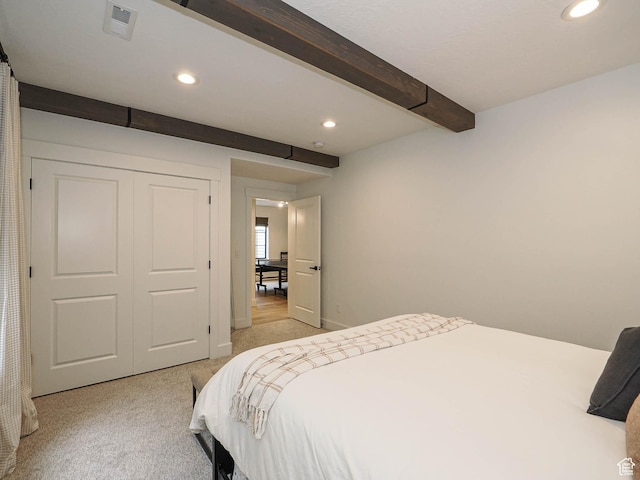 bedroom with beam ceiling, light carpet, and recessed lighting