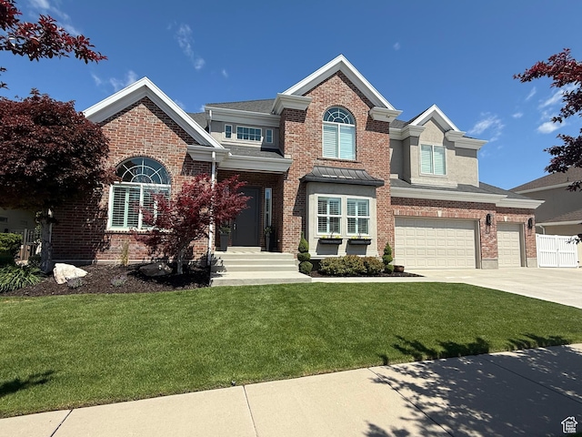 423 E Woodridge Oak Dr S, Draper, UT 84020 - view of front of house with a front lawn, concrete driveway, brick siding, and an attached garage