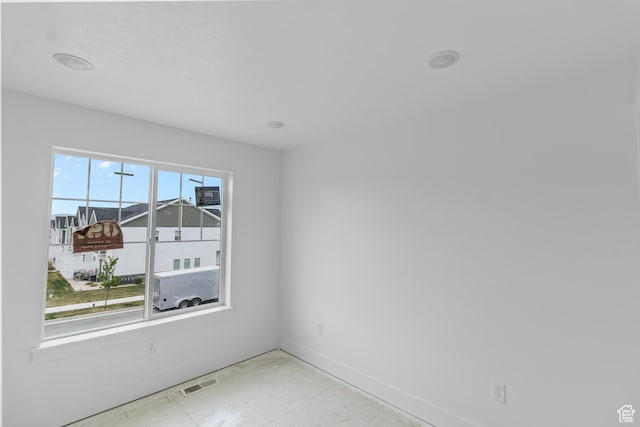 spare room with baseboards